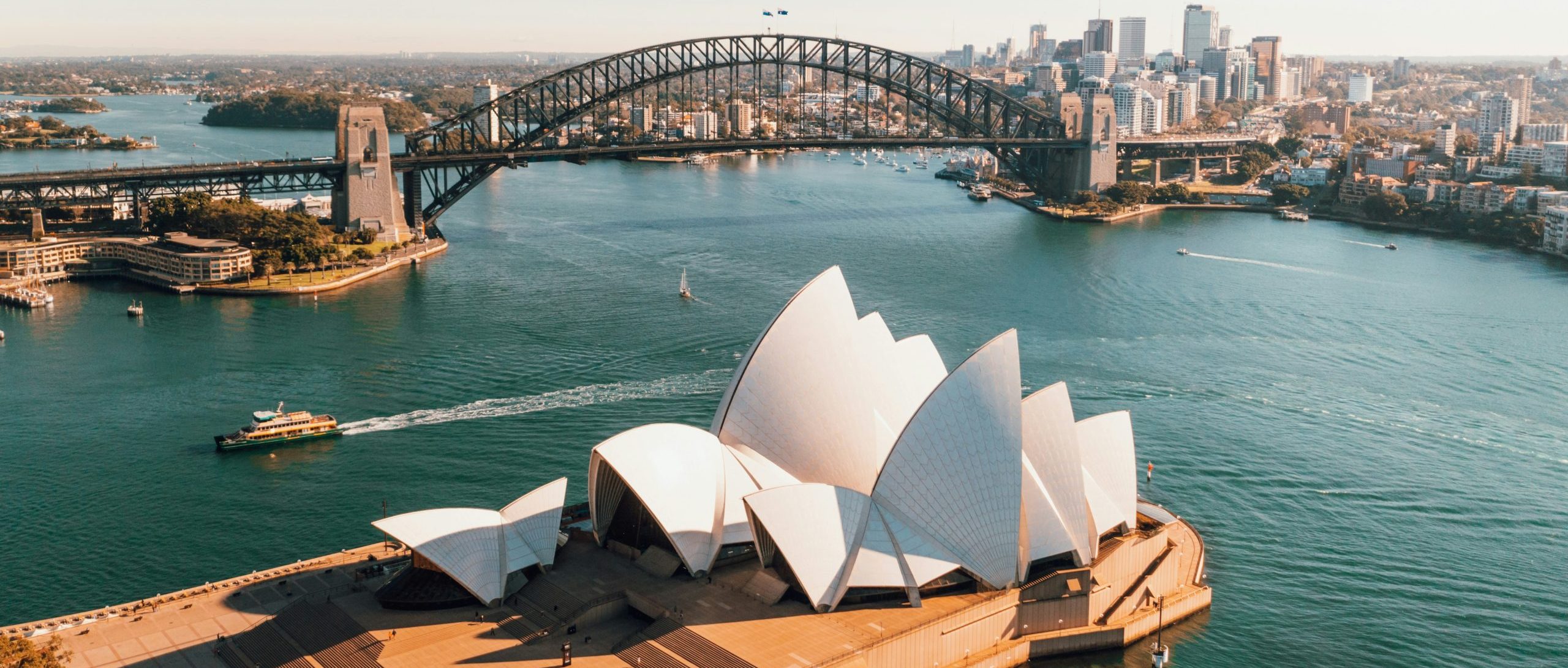 Aerial view of Sydney, Sydney Opera house in the foreground, Sydney Harbour Bridge in the background.