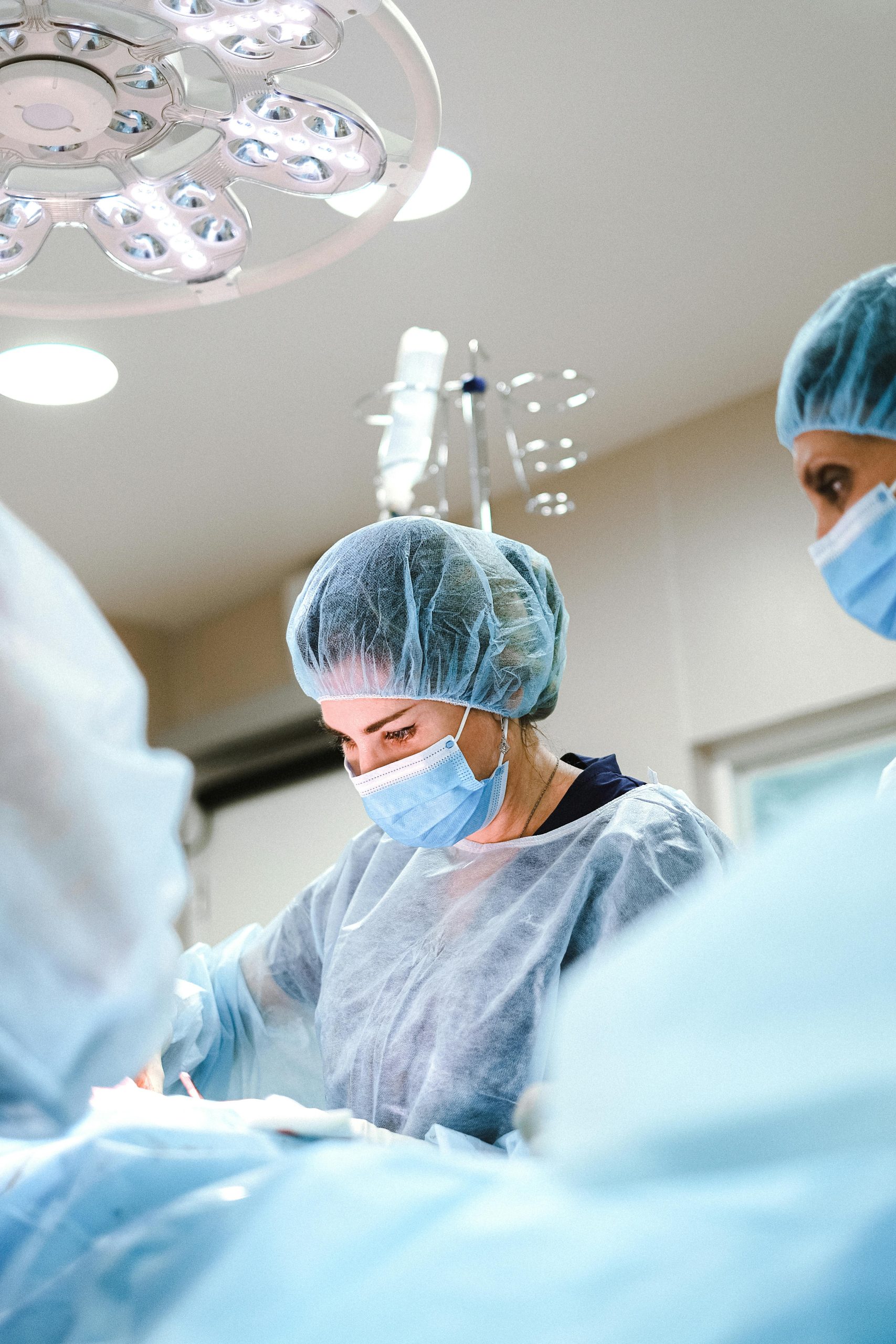 pexels-shvetsa-4421494 A female doctor is performing a surgery.