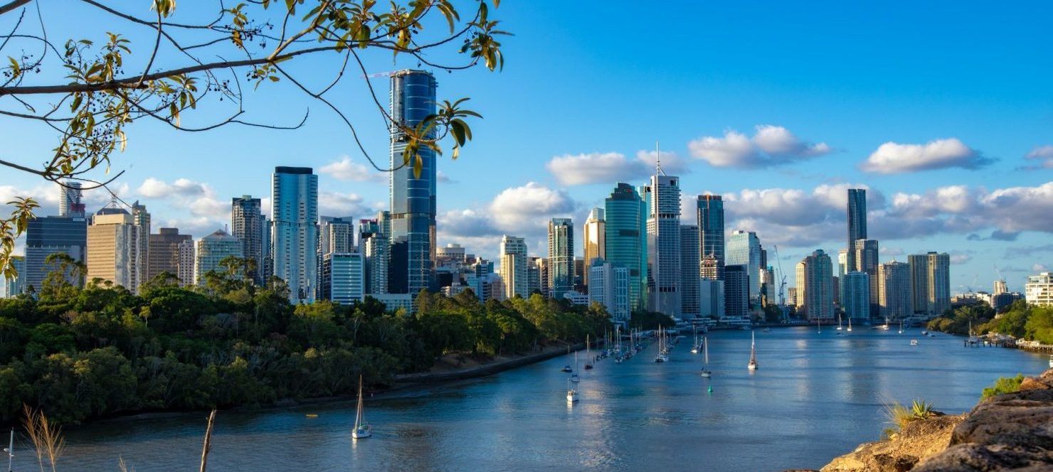 Views towards Brisbane's skyline. River with sailboats on the foreground